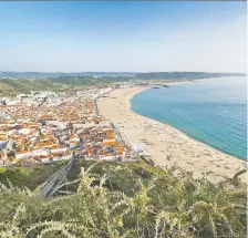  ?? BONUCCELLI/ RICK STEVES' EUROPE
DOMINIC ARIZONA ?? Nazaré, two hours north of Lisbon in Portugal, hugs its wide beach on the Atlantic Ocean, waiting patiently for tourists to return.