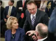  ?? CAROLYN KASTER — THE ASSOCIATED PRESS FILE ?? In this file photo, Education Secretary Betsy DeVos, left, acting White House chief of staff Mick Mulvaney, center, and Louisiana Gov. John Bel Edwards talks before President Donald Trump arrives to speak at the 2019 White House Business Session with Our Nation’s Governors in the State Dining Room of the White House in Washington.