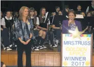  ??  ?? St. Mary’s Bryantown Catholic school teacher Michelle Truss is introduced by Principal Sharon Caniglia during a surprise assembly in which it was announced Truss was named a 2017 Golden Apple recipient by the Archdioces­e of Washington.