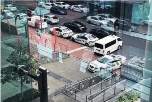  ?? PHOTO: RNZ ?? Police vehicles gather outside the Sofitel Hotel yesterday.