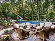  ?? METRO NEWS SERVICE PHOTO ?? Backyard pools can make a backyard retreat that much more enjoyable. Landscapin­g offers the softness and beauty that adds a finishing touch to poolside retreats.