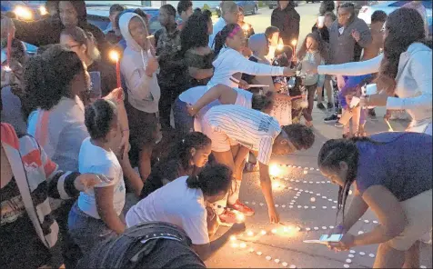  ?? BECKY JACOBS/POST-TRIBUNE ?? Mourners gathered in May for a vigil after David Anderson, 11, was fatally shot at an East Chicago park.