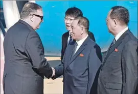  ?? Matthew Lee Pool Photo ?? SECRETARY of State Mike Pompeo, left, and Kim Yong Chol, North Korea’s former military intelligen­ce chief, exchange greetings in Pyongyang.