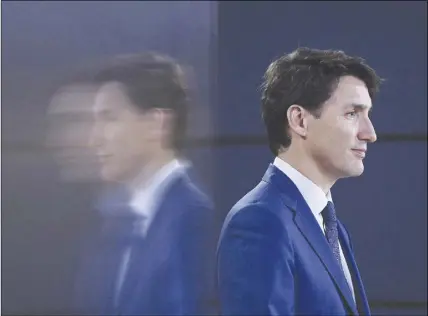  ?? CP PHOTO ?? Prime Minister Justin Trudeau is re ected in a TV screen as he speaks at a news conference in Ottawa.