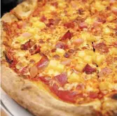  ?? ?? To have pineapples on a pizza or not? This is the Cowabunga Plus Hawaiian pizza.