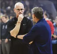  ?? Jessica Hill / Associated Press file photo ?? UConn men’s head coach Dan Hurley, left, talks with women’s head coach Geno Auriemma during the UConn men’s and women’s basketball teams’ annual First Night celebratio­n in Storrs on Oct. 18, 2019.