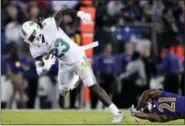  ?? GAIL BURTON — THE ASSOCIATED PRESS FILE ?? In this file photo, Miami Dolphins running back Jay Ajayi breaks free from Baltimore Ravens free safety Lardarius Webb.The NFL-leading Eagles have bolstered their offense by acquiring running back Jay Ajayi from the Miami Dolphins for a fourth-round...