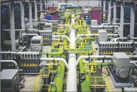  ?? AP PHOTO/EMILIO MORENATTI ?? A worker walks over the pipeline that transports seawater to filters at Europe’s largest desalinati­on plant for drinking water located in Barcelona, Spain, on Tuesday.