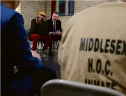 ?? JESSICA RINALDI/GLOBE STAFF ?? Louis L. Reed (left) and Sheriff Peter Koutoujian spoke to participan­ts at Middlesex House of Correction and Jail.