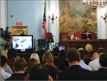  ?? KENA BETANCUR / AFP ?? Bombing suspect Ahmad Khan Rahimi participat­es in his first court appearance via video in Elizabeth, New Jersey while he remains at University Hospital in Newark on Thursday.