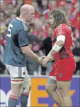  ??  ?? Munster’s Paul O'Connell shakes the hand of Martin Castrogiov­anni, Toulon, after the game. Alas, the dream of a Cardiff final re-run has been dashed for the Red Army.