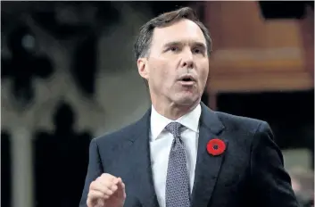  ?? THE CANADIAN PRESS FILES ?? Finance Minister Bill Morneau stands during question period earlier this month in the House of Commons. Parliament’s spending watchdog says Liberal changes to passive investment­s rules for small businesses could rake in up to $ 6 billion annually in...