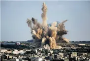  ?? Dusan Vranic / Associated Press ?? An Israeli air strike blasts Gaza City. Cross-border attacks went on with peace negotiatio­ns on hold.