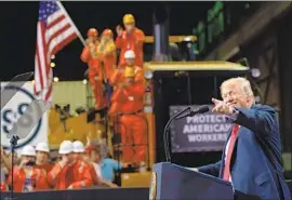  ?? Saul Loeb AFP/Getty Images ?? PRESIDENT TRUMP visits a newly reopened steel plant in Granite City, Ill., a town outside St. Louis. “I could be one of you,” the president told the steelworke­rs.