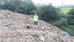  ??  ?? An estimated 50,000 tonnes of waste has been landfilled at a site in Great Harwood and a number of skips containing mixed household and business waste were observed