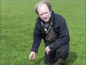  ??  ?? Riverstown farmer John Graham points to the poor quality grass in fields right now.