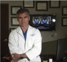  ?? PHOTO BY JEFF GRITCHEN, ORANGE COUNTY REGISTER/SCNG ?? Dr. Christophe­r Duma stands in front of an MRI of Jack Sage’s brain at his office in Irvine, Calif., Feb. 28.