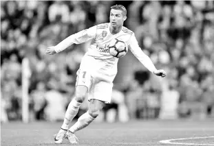  ??  ?? Real Madrid’s Portuguese forward Cristiano Ronaldo controls the ball during the Spanish league football match Real Madrid CF against Malaga CF on 25, November 2017 at the Santiago Bernabeu stadium in Madrid. - AFP photo