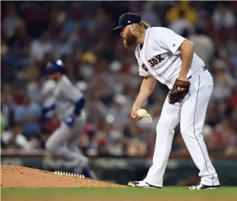  ?? CHRISTOPHE­R EVANS / BOSTON HERALD ?? CAN’T PICK THEM UP: Andrew Cashner collects himself after giving up a go-ahead home run to the Blue Jays’ Justin Smoak in the sixth inning of the Red Sox’ 10-4 loss last night at Fenway.