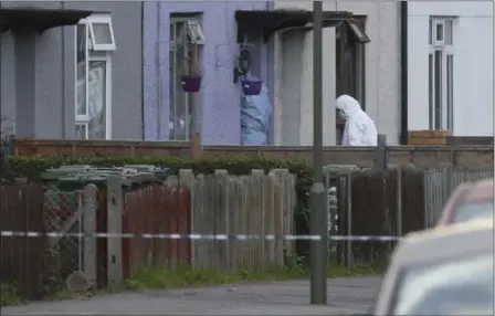  ?? JONATHAN BRADY — PA VIA AP ?? Police forensic officers enter a property in Sunbury-on-Thames, southwest London, as part of the investigat­ion into Friday’s Parsons Green bombing, Saturday Sept, 16. British police made what they called a “significan­t” arrest Saturday in southern...