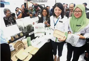  ??  ?? Going green: Yeo (second from right) looking at biodegrada­ble products on display at the Convention Centre.