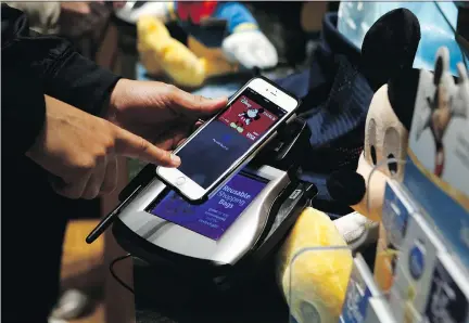  ?? JASON DECROW/INVISION FOR DISNEY/THE ASSOCIATED PRESS ?? This Disney Store location in New York’s Times Square has begun accepting Apple Pay. ‘Canada is a bit (of a) different dynamic than in the U.S. — given the oligopoly in Canada,’ says John Aiken, a financial services analyst at Barclays Capital.