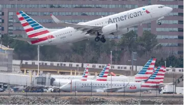  ??  ?? File photo shows a Boeing 737 flown by American Airlines passes by the Lockheed Martin building as it takes off from Ronald Reagan Washington National Airport in Arlington, Virginia. — AFP photo