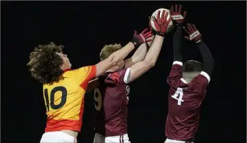  ??  ?? Ben Maddock and Eoin O’Leary of St. Martin’s outnumberi­ng David Gouldson (Sarsfields) two to one.