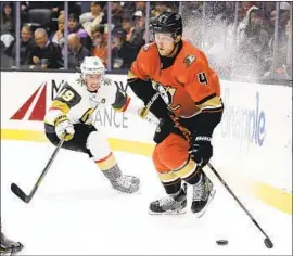  ?? Marcio Jose Sanchez Associated Press ?? CAM FOWLER controls the puck in front of Reilly Smith of the Golden Knights during the first period. Fowler had a goal and an assist in the Ducks’ 4-3 win.