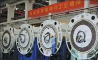  ?? WU JIN / FOR CHINA DAILY ?? An employee works on a wind power machine in Mingyang’s factory in Zhongshan, Guangdong province.