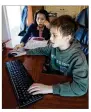  ?? STEVEN SENNE / AP ?? Kim Horrigan sits with her son Conor Horrigan, 8, as Conor does homework at their home, in Quincy, Mass., on April 13 . Conor has been doing remote learning.