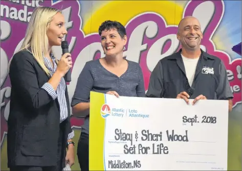  ?? LAWRENCE POWELL ?? Sheri and Stacy Wood were handed a cheque for $675,000 in a ceremony at the PSP Community Recreation Centre in Greenwood Sept. 27. They won Atlantic Lottery’s Set for Life and opted for a lump sum instead of $1,000 a week for 25 years. They’re seen here with Atlantic Lottery’s Abby MacDonald.
