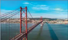  ?? ?? Left: Aerial panorama view over the 25 de Abril Bridge, Lisbon. Opposite: Grand Anse Beach on the island of Grenada.