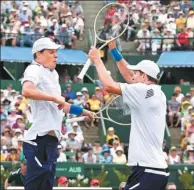  ?? AP FILE ?? Bob Bryan (left) and his brother Mike celebrate defeating Australia’s Lleyton Hewitt and John Peers in their Davis Cup doubles match in Melbourne, last March. The American twins have racked up 16 Grand Slam victories in their career.