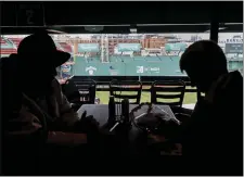  ?? PAUL CONNORS — BOSTON HERALD ?? Red Sox fans Landon Schubert, left, of Middlebury, Vt., and his friend Jonathan Duffy, right, of Reading, sit at a table with a field view from the newly-opened Aura Club.