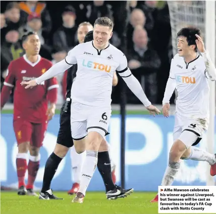  ??  ?? > Alfie Mawson celebrates his winner against Liverpool, but Swansea will be cast as favourites in today’s FA Cup clash with Notts County