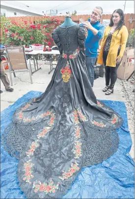  ?? CHRIS RILEY — THE TIMES-HERALD ?? Mario Saucedo, with the Solano AIDS Coalition, works on a memorial dress that will be one of the featured Catrina gown in next weekend’s Dia de los Muertos event in downtown Vallejo.