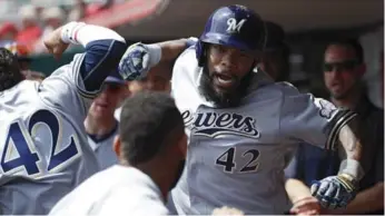  ?? JOE ROBBINS/GETTY IMAGES ?? Brewer Eric Thames, above, celebrated 11 homers in April, while Bryce Harper of the Nationals, left, is hitting .391 with nine bombs and 26 RBIs.