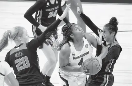  ?? ERIC GAY/AP ?? South Carolina forward Aliyah Boston looks to shoot between Oregon State forward Ellie Mack, left, and forward Jelena Mitrovic during a second-round NCAA Tournament game Tuesday.