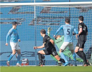  ??  ?? Manchester City’s John Stones fires home what proved to be the winner