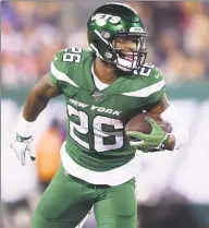  ?? Emilee Chinn / Getty Images ?? Le’Veon Bell of the New York Jets carries the ball during the second half against the New England Patriots. Bell had a seasonhigh 70 yards on 15 carries in the loss.