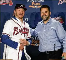  ?? ALYSSA POINTER / ALYSSA.POINTER@AJC.COM ?? Braves general manager Alex Anthopoulo­s (right) introduces newly signed third baseman Josh Donaldson during a news conference Tuesday at SunTrust Park.