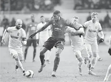  ??  ?? FC Zorya Luhansk Jaba Lipartia (left) and Dmytro Grechyshki­n (right) vie with Manchester United FC’s Paul Pogba (centre) during the UEFA Europa League football match between FC Zorya Luhansk and Manchester United FC at the Chornomore­ts stadium in...