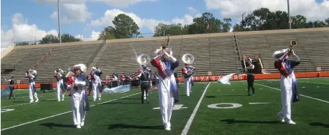  ?? Staff photo by Greg Bischof ?? ■ Members of the Prairiland High School Marching Band perform Saturday at the 2018 Four States High School Marching Band Contest. The five-hour event took place at Tiger Stadium in Grim Park.