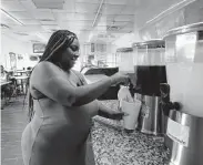  ?? ?? Ashley Bush refills her sweet tea during lunch at the soon-to-be former location of Alfreda’s Soul Food.