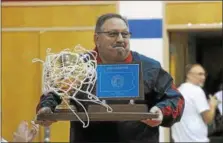  ?? GENE WALSH — DIGITAL FIRST MEDIA ?? Head coach Jim Romano holds up the state championsh­ip trophy as he is introduced during assembly April 27, 2018.