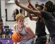  ?? (NWA Democrat Gazette/Caleb Grieger) ?? Bergman’s Bryson Bauer (center) works inside against the Osceola defense in the Panthers’ 55-50 overtime victory Friday in Elkins. Bauer led Bergman with 15 points.