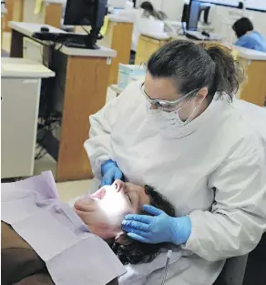  ?? PHOTOS: DAWN VILLELLA/ THE ASSOCIATED PRESS/FILES ?? Dental therapists perform procedures that go beyond dental hygiene, such as fillings.