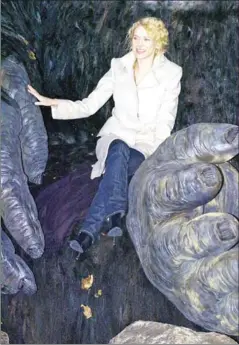  ?? STAN HONDA/AFP ?? Actress Naomi Watts poses in the hands of a giant King Kong sculpture in New York’s Times Square to promote the world premiere of on December 5, 2005.