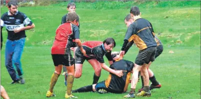  ?? 06_ a44rugby11 ?? Donald Self reaches for possession with Mid Argyll team-mate William Wilson on hand to support in a highly competitiv­e match between S1/2 teams from Mid Argyll and Lochaber.